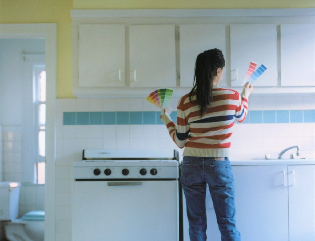A woman choosing a color for a kitchen
