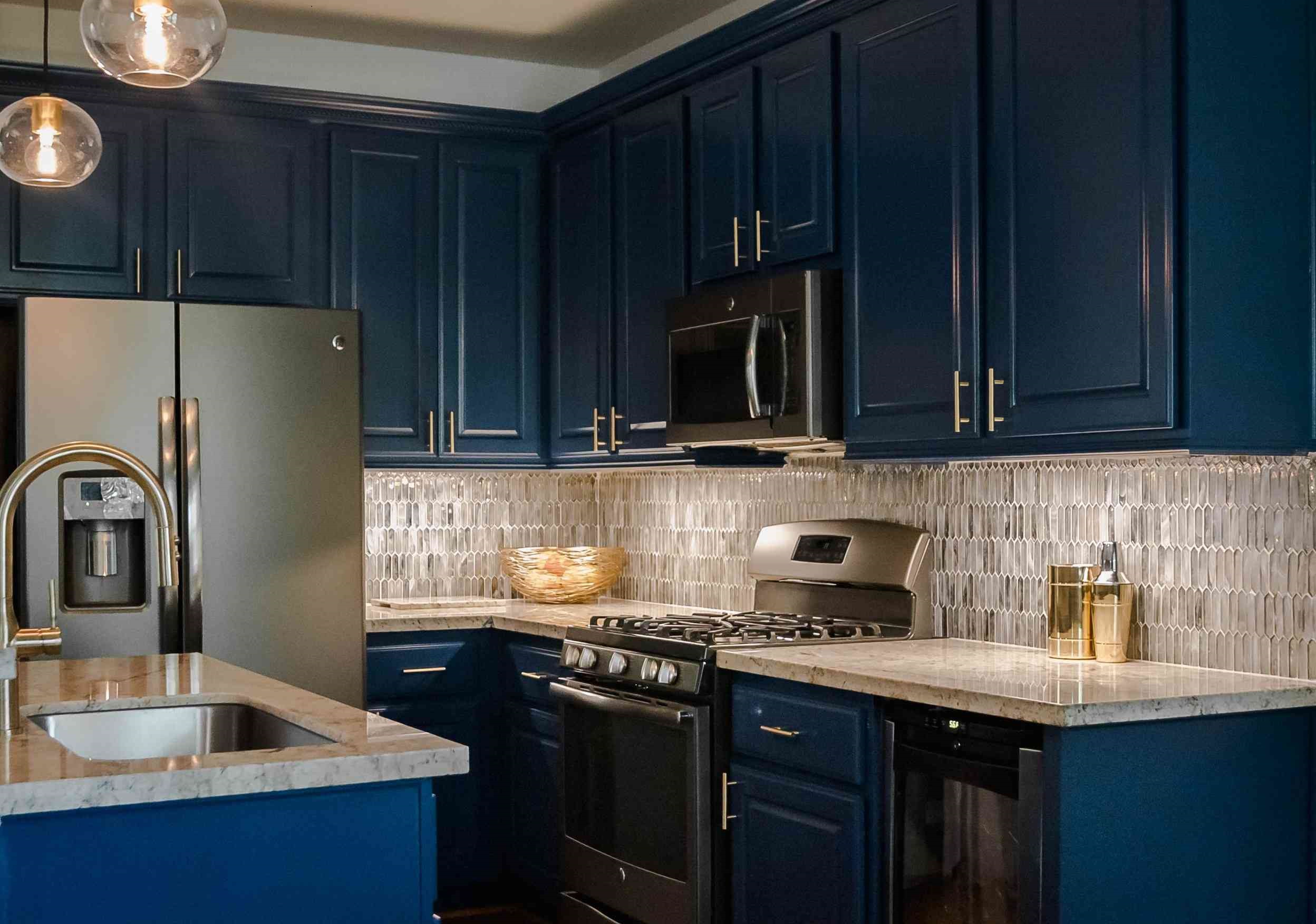 A kitchen with moody blue colors