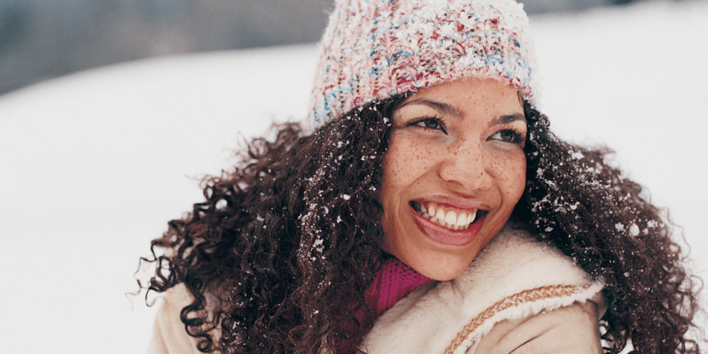 woman with curly hair out in the snow